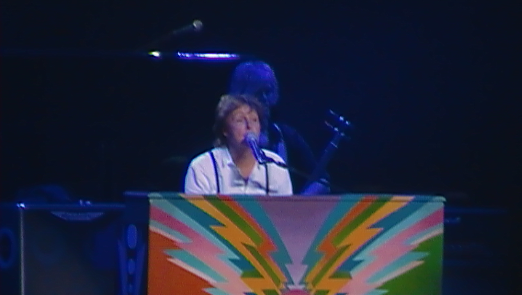 Paul, wearing his white dress shirt and black suspenders, playing his psychedelic upright piano during Hey Jude, the end of the proper set. Front view.
